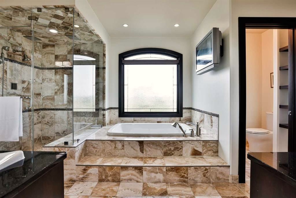 Residential Ensuite design with dark wood finishes and genuine onyx tile