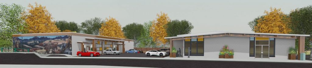 Small commercial buildings with parked cars.