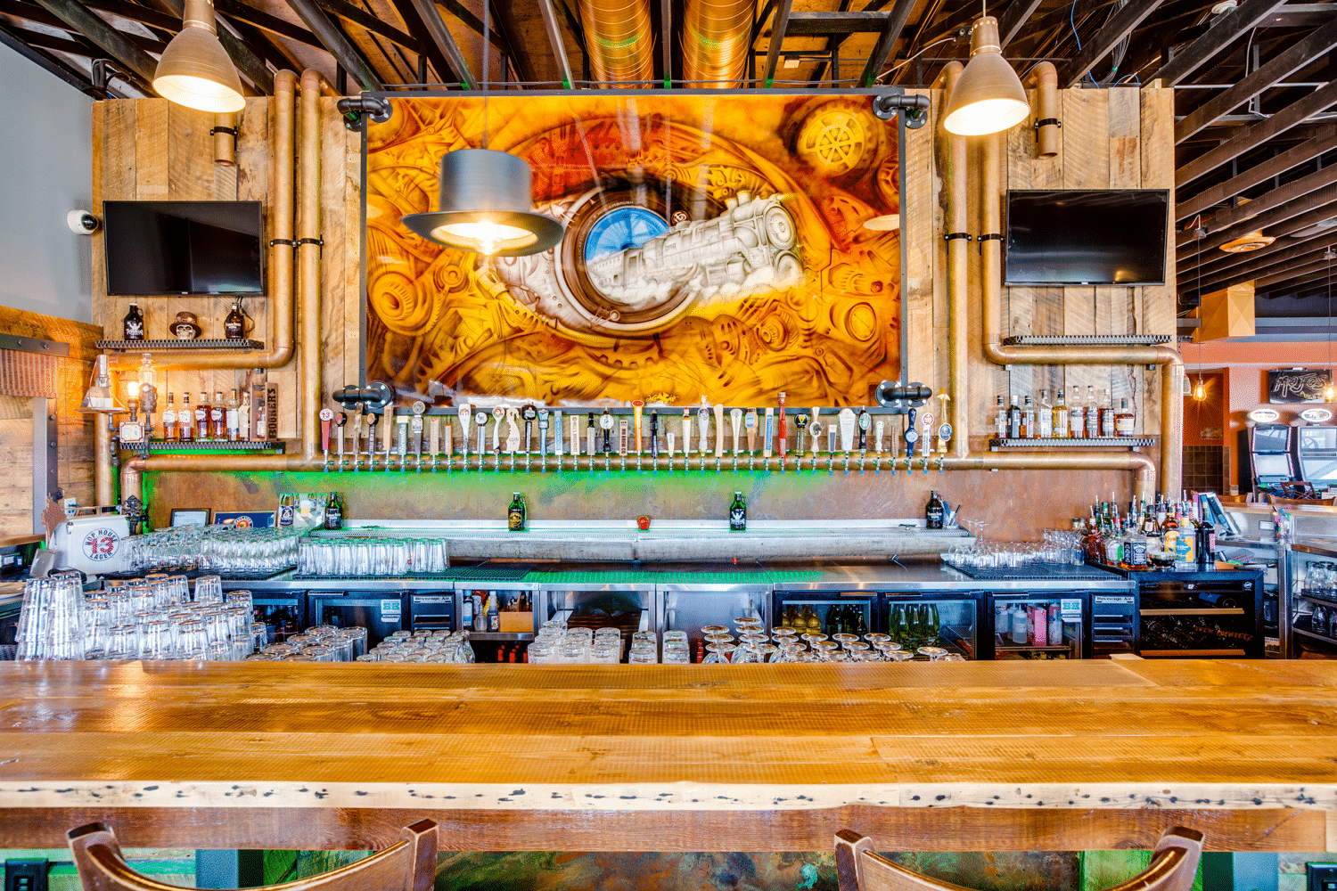 Rustic bar with artwork and multiple taps.